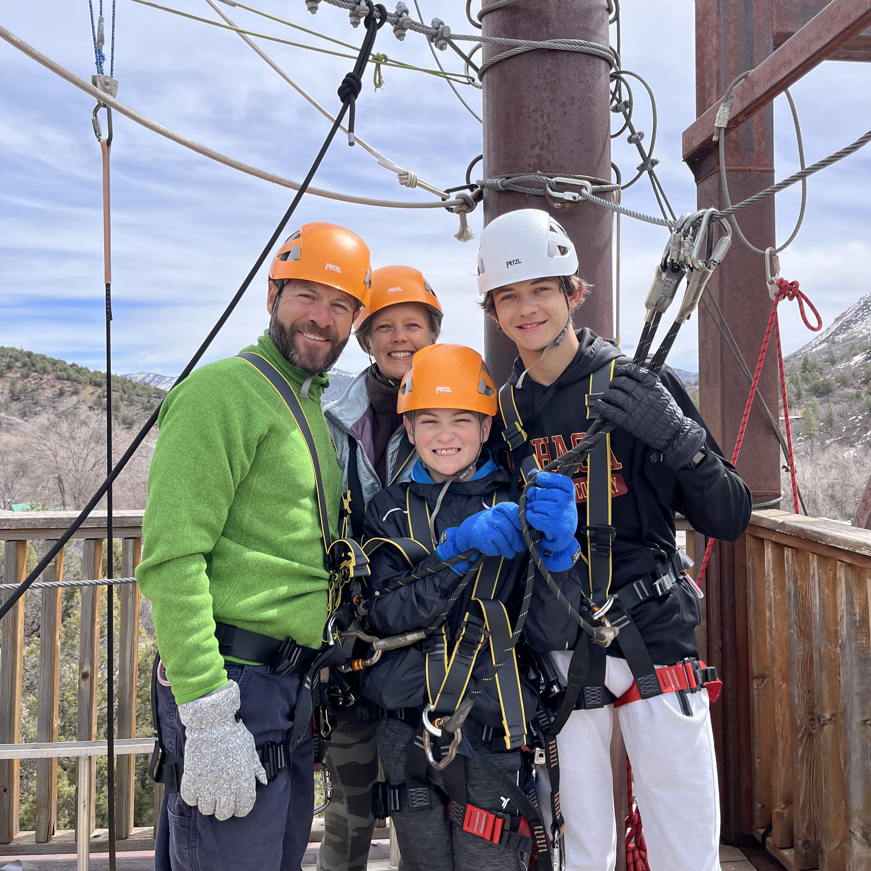 family wearing helmets and rope harnasses